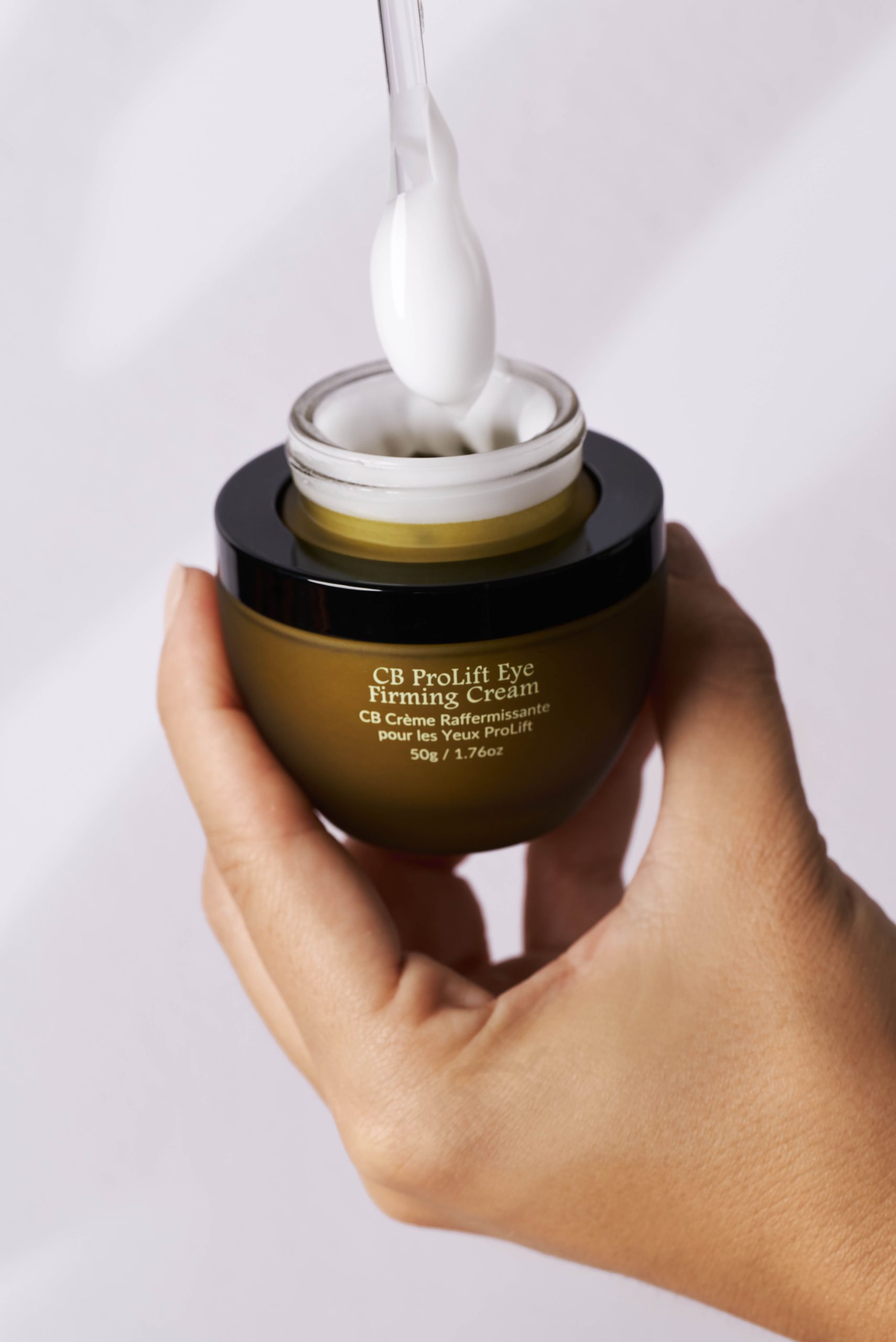 Hand holding the CB ProLift Eye Firming Cream