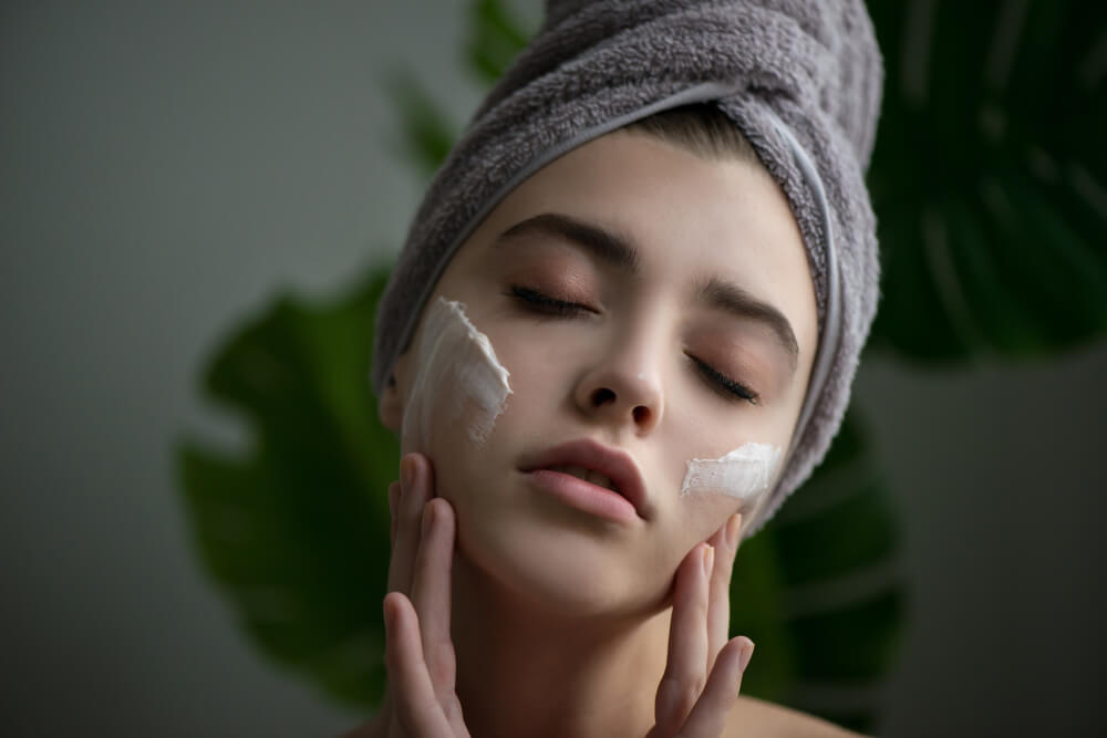 Woman applying CBD face cream