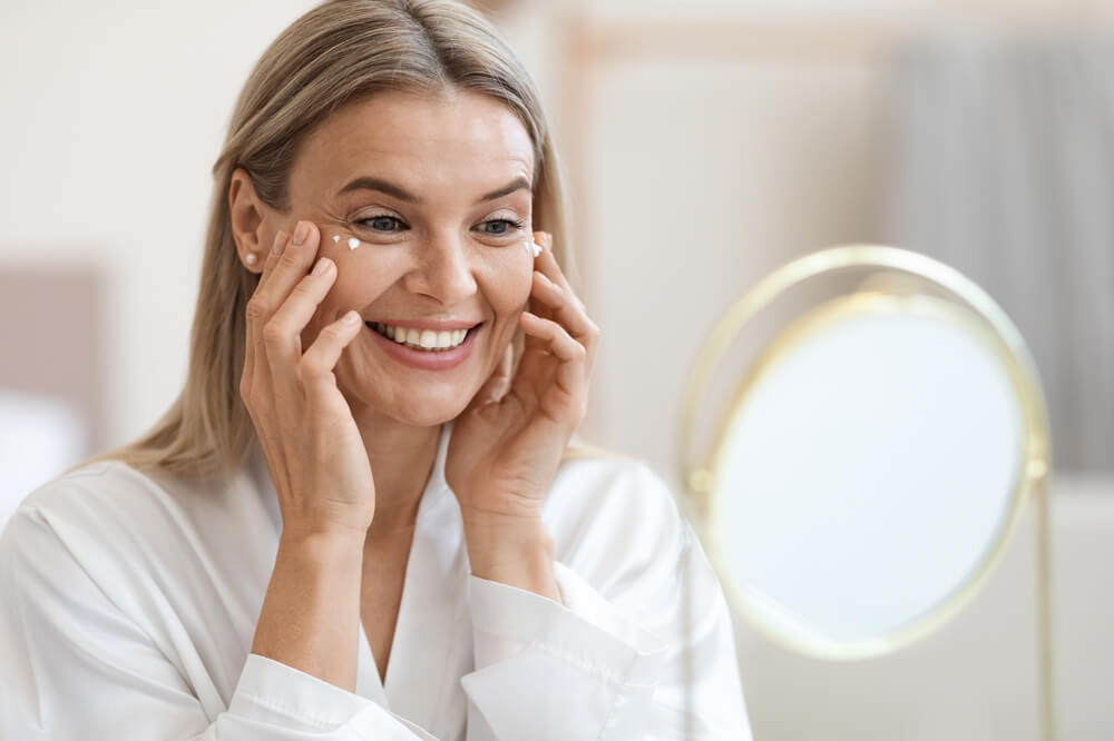 Woman using eye cream